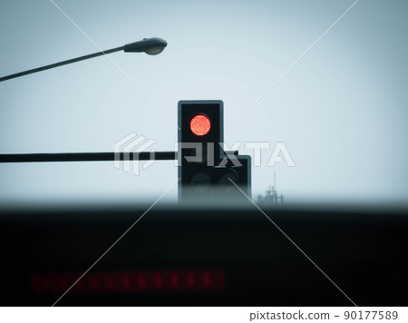 View from inside a car of a red traffic light over urban intersection. Tranport and regulation concept. View from inside a car of a red traffic light over urban intersection. Tranport and regulation concept. 90177589