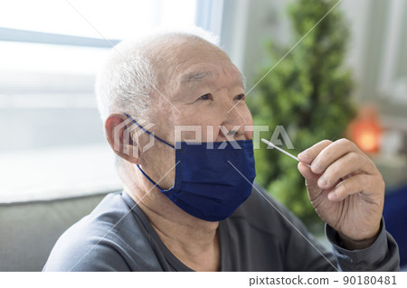 Asian senior man doing self test for COVID-19 at  90180481