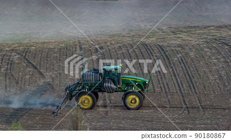 Tractor spray fertilizer spraying pesticides on green field, agriculture background concept 90180867