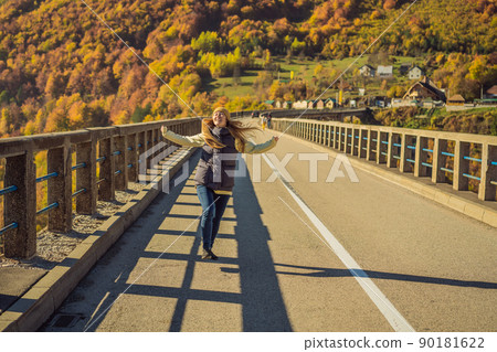 Montenegro. Woman touriste in background of Dzhurdzhevich Bridge Over The River Tara foggy morning. Travel around Montenegro concept. Sights of Montenegro 90181622
