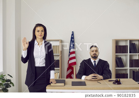 Female witness swears before testifying that she will tell truth and nothing but truth. Female witness swears before testifying that she will tell truth and nothing but truth. 90182835