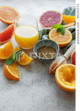 Glass of juice and citrus fruits. 90183572