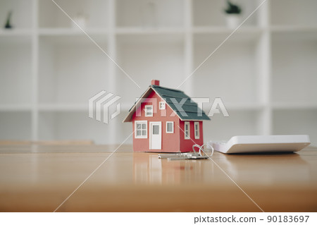 Small house model, keys and calculator on wooden table. New house, insurance and real estate concept Small house model, keys and calculator on wooden table. New house, insurance and real estate concept 90183697