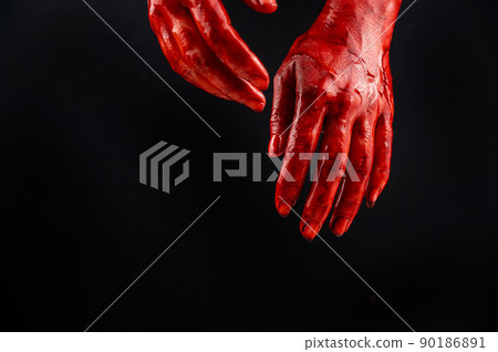 Women's hands in blood on a black background. 90186891