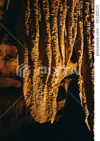 Close up shot of cave formations underground stalagmites and stalactites Close up shot of cave formations underground stalagmites and stalactites 90188525