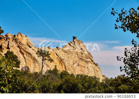 Landscape of rock peaks against trees and blue sky Landscape of rock peaks against trees and blue sky 90188653