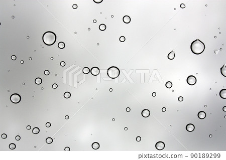 Water drops against a glass window on a gray sky 90189299