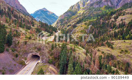 Road through mountain tunnel in rocky mountains Road through mountain tunnel in rocky mountains 90189449