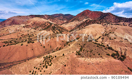 Mountains with colorful layers of yellow to red sand Mountains with colorful layers of yellow to red sand 90189494