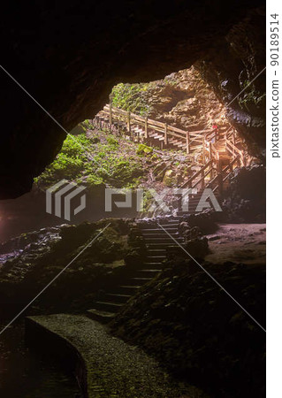 Large cave opening with stairs leading outside Large cave opening with stairs leading outside 90189514