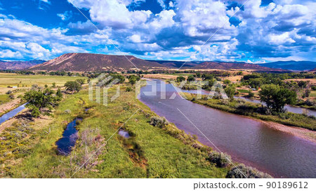 View of river in desert with mountains in distance View of river in desert with mountains in distance 90189612