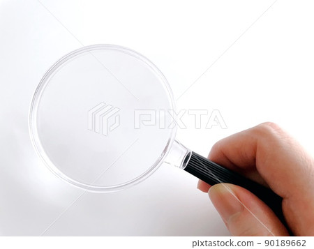 Female hand with magnifying glass 90189662