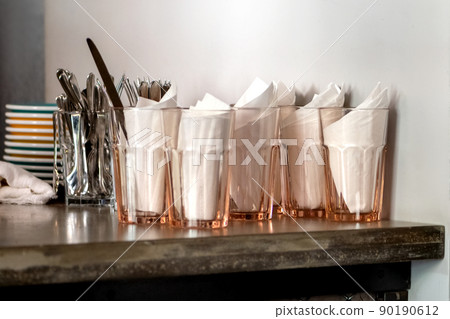 clean dishes on tabletop of counter in coffee bar or restaurant 90190612