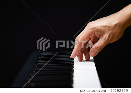 male musician hand playing on piano keys. music background male musician hand playing on piano keys. music background 90192859
