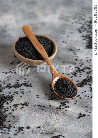 Bowl of Indian spice Black cumin (nigella sativa or kalonji) seeds close up with a wooden spoon Bowl of Indian spice Black cumin (nigella sativa or kalonji) seeds close up with a wooden spoon 90193783