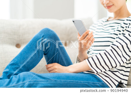 Middle woman (parts) operating a smartphone 90194940