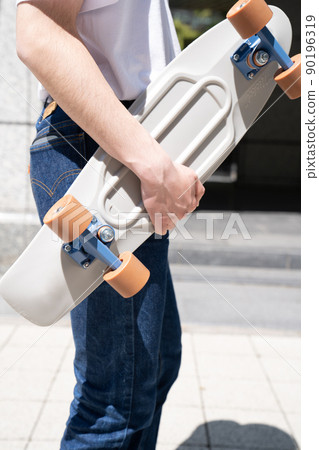 Male penny cruiser with a skateboard Male penny cruiser with a skateboard 90196319