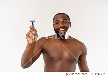 Young Afro American Man Shaving in Bathroom. Personal Morning Routine. Hygiene at Morning Concept. Young Afro American Man Shaving in Bathroom. Personal Morning Routine. Hygiene at Morning Concept. 90196394
