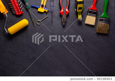 Construction tools on black slate background. Construction concept Construction tools on black slate background. Construction concept 90196801