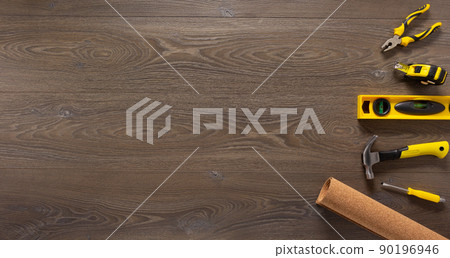 Wood laminate and tools on floor background texture. Wooden laminate top view Wood laminate and tools on floor background texture. Wooden laminate top view 90196946