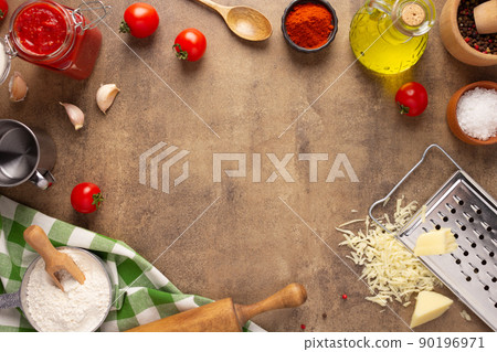 Homemade pizza  with ingredients on table. Flour for pizza at tabletop 90196971