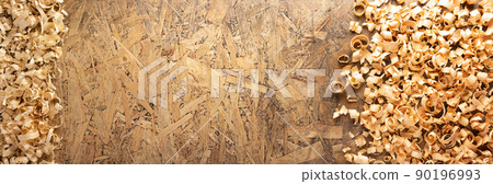 Wood shavings at table background. Wooden shaving on old plank board Wood shavings at table background. Wooden shaving on old plank board 90196993