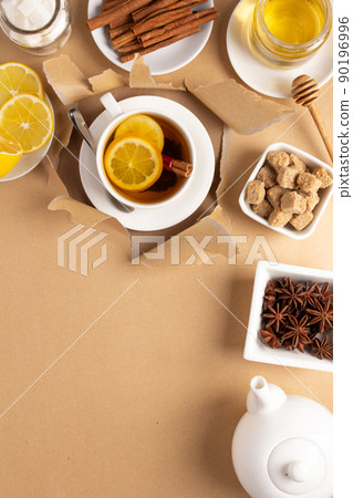 Cup of tea with lemon and honey on torn paper. Mug full green tea Cup of tea with lemon and honey on torn paper. Mug full green tea 90196996