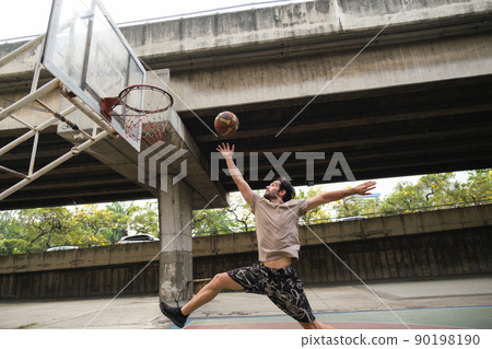 Two caucasian men pratice baskegball in court at urban street. Two caucasian men pratice baskegball in court at urban street. 90198190