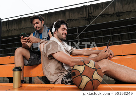 Two causian basketball player resting and ralax. Two causian basketball player resting and ralax. 90198249