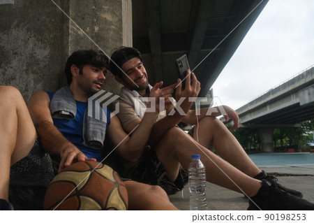 Two causian basketball player resting and ralax. 90198253