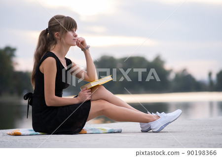 Young woman resting in summer park reading a book. Education and sudy concept. Young woman resting in summer park reading a book. Education and sudy concept. 90198366