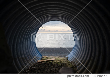 View from water drainage pipe on sea beach. View from water drainage pipe on sea beach. 90198446