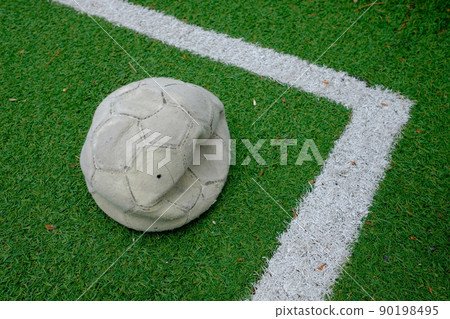deflated soccer ball on green grass sport field. deflated soccer ball on green grass sport field. 90198495