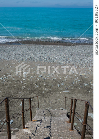 Staircase to beach. Blue water and stones on beach Staircase to beach. Blue water and stones on beach 90198527