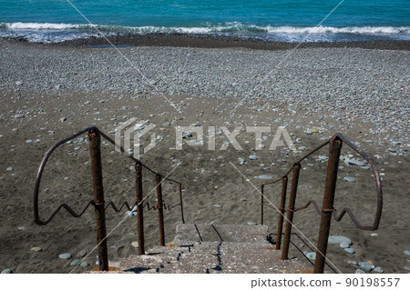 Staircase to beach. Blue water and stones on beach Staircase to beach. Blue water and stones on beach 90198557