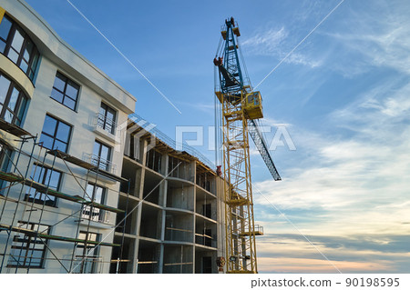 Tower cranes at high residential apartment buildings construction site. Real estate development Tower cranes at high residential apartment buildings construction site. Real estate development 90198595