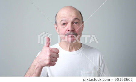 Happy handsome man showing thumbs up Happy handsome man showing thumbs up 90198665