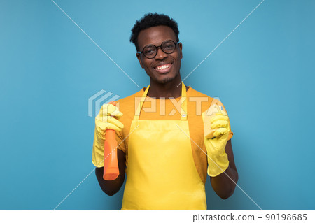 Handsome african man from cleaning service ready for tidying up your apartment Handsome african man from cleaning service ready for tidying up your apartment 90198685