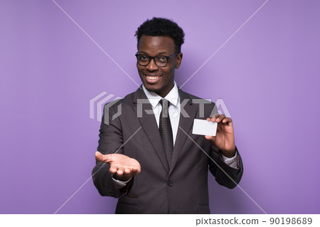 African young man bank manager showing credit card for online shopping African young man bank manager showing credit card for online shopping 90198689