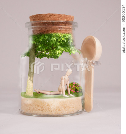 Inside the jar is a small mannequin and a tree. The mannequin is sunbathing. The azaleas are beautiful. Inside the jar is a small mannequin and a tree. The mannequin is sunbathing. The azaleas are beautiful. 90200154