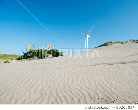 Windmills for wind power generation in the blue sky and coast. Hazaki Wind Farm on the Sudahama coast in Kamisu City, Ibaraki Prefecture. Windmills for wind power generation in the blue sky and coast. Hazaki Wind Farm on the Sudahama coast in Kamisu City, Ibaraki Prefecture. 90205034