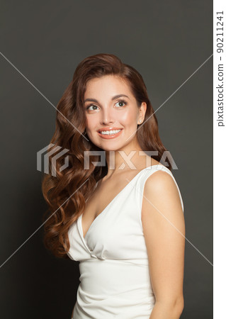 Happy smiling woman with long healthy shiny curly hairdo and natural makeup. Pretty female model ait 90211241