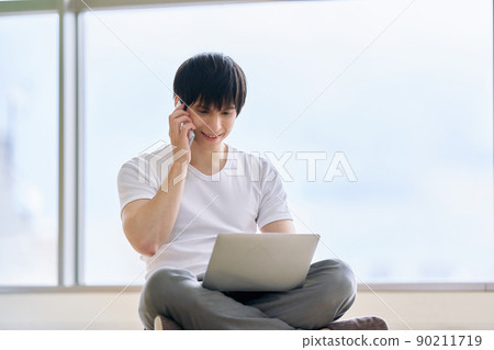 Young man typing a laptop Young man typing a laptop 90211719