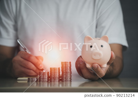 Man hand holding piggy bank on table, saving money wealth and financial concept, Business, finance, investment, Financial planning. Business financial saving for future concept. Man hand holding piggy bank on table, saving money wealth and financial concept, Business, finance, investment, Financial planning. Business financial saving for future concept. 90213214