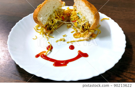 Close-up of delicious fresh home made burger with lettuce, cheese, onion and tomato on a white plate on wooden table background Close-up of delicious fresh home made burger with lettuce, cheese, onion and tomato on a white plate on wooden table background 90213622