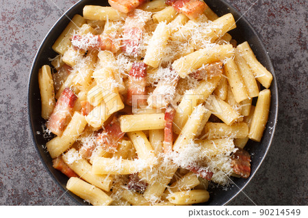 Pasta alla Gricia typical italian pasta with pecorino cheese and guanciale closeup in the plate. Horizontal top view Pasta alla Gricia typical italian pasta with pecorino cheese and guanciale closeup in the plate. Horizontal top view 90214549