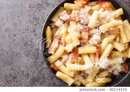 Pasta alla gricia plate of delicious italian pasta with guanciale and pecorino, typical italian and roman food closeup in the plate. Horizontal top view Pasta alla gricia plate of delicious italian pasta with guanciale and pecorino, typical italian and roman food closeup in the plate. Horizontal top view 90214550