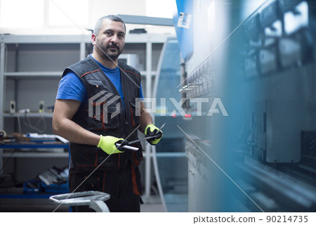 A smart factory worker or engineer makes machines in a production workshop. The concept of industry and engineering. Selective focus 90214735