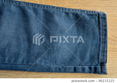 Seam blue denim cotton jeans leg detail, jean fabric texture background 90215125