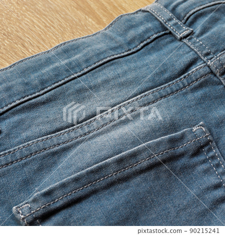 Close up detail of back pocket of light blue jeans Close up detail of back pocket of light blue jeans 90215241